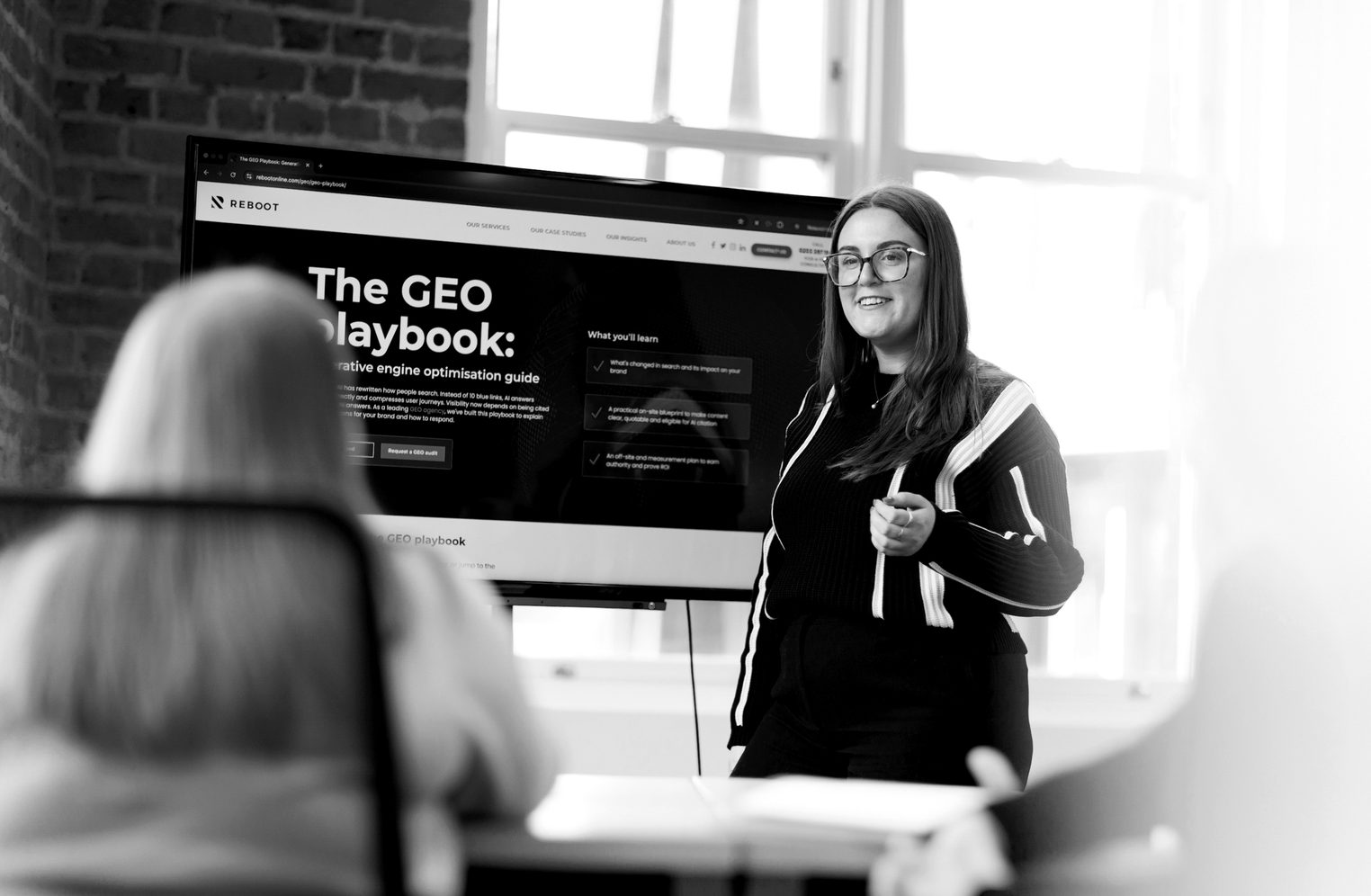 A Reboot team member presenting the GEO playbook at a roundtable event